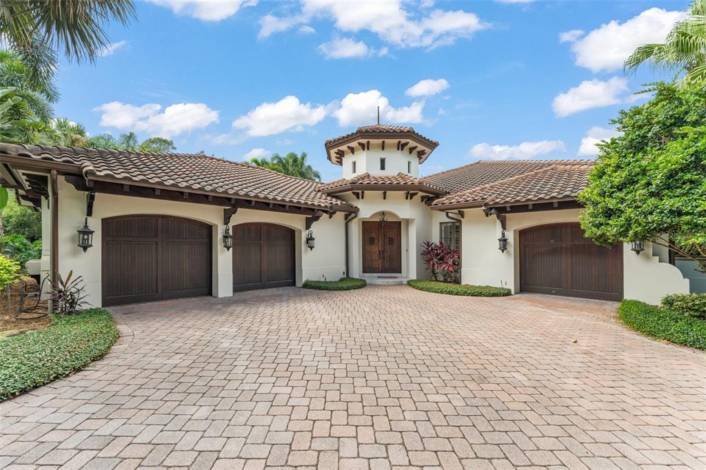 4812 Alexandra Garden Court Windermere, FL 34786 - Photo 63 of 65 a front view of a house with a yard and garage