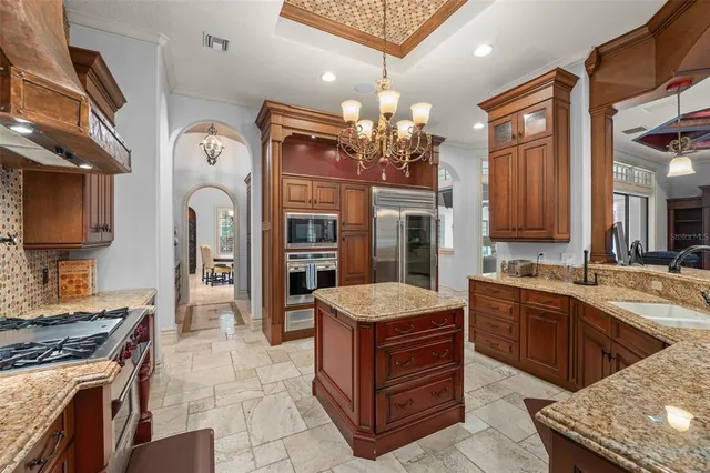 a kitchen with stainless steel appliances granite countertop a stove and cabinets