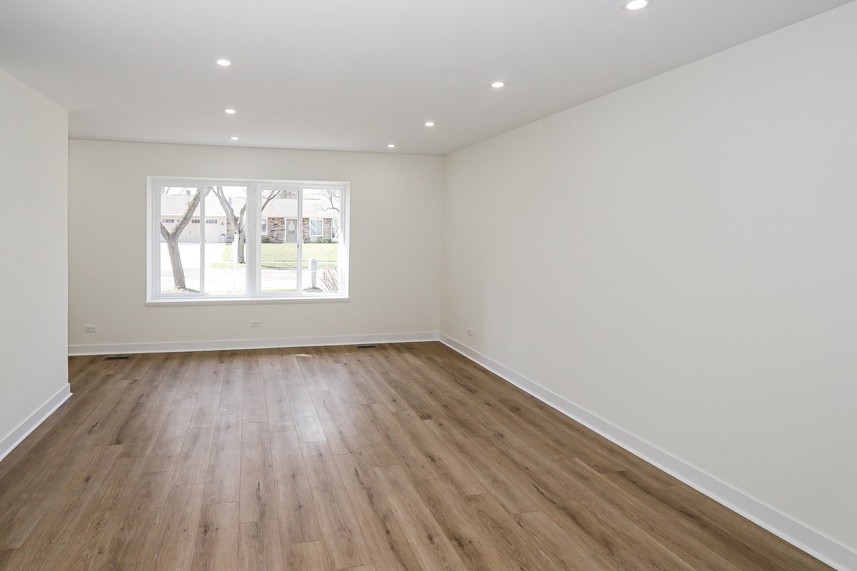 464 Winterwood Drive Roselle, IL 60172 - Photo 14 of 39 an empty room with wooden floor and windows