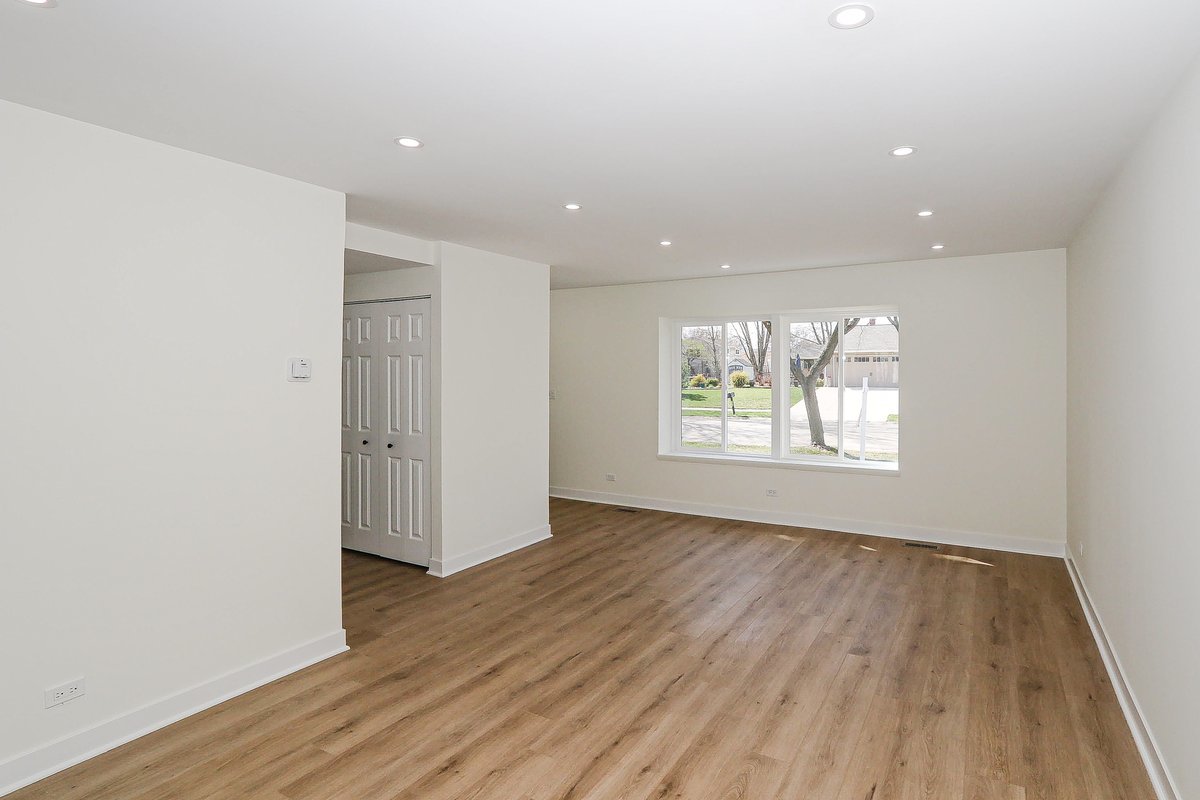 464 Winterwood Drive Roselle, IL 60172 - Photo 15 of 39 an empty room with wooden floor and windows