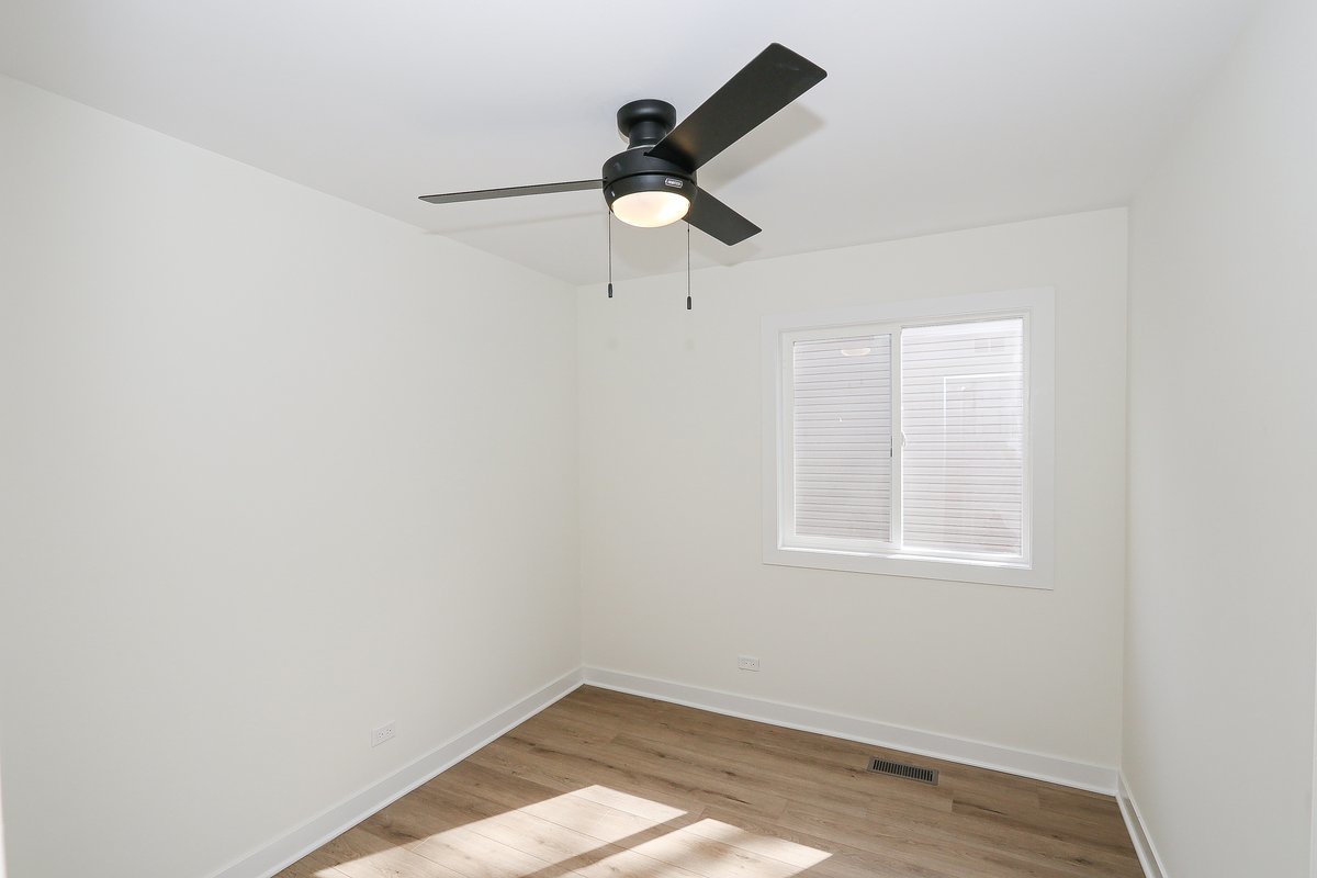 464 Winterwood Drive Roselle, IL 60172 - Photo 23 of 39 a view of empty room with window and ceiling fan