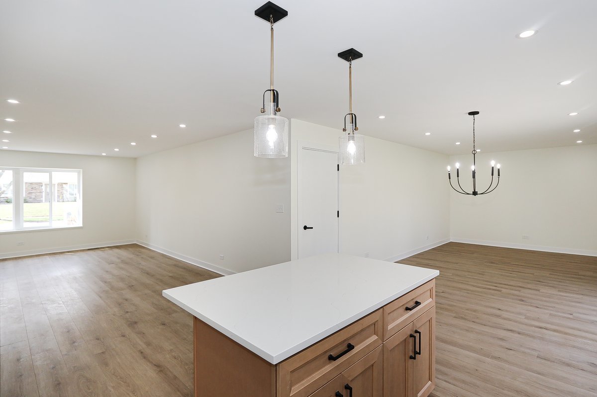 464 Winterwood Drive Roselle, IL 60172 - Photo 7 of 39 a view of a kitchen with a sink wooden floor and a chandelier