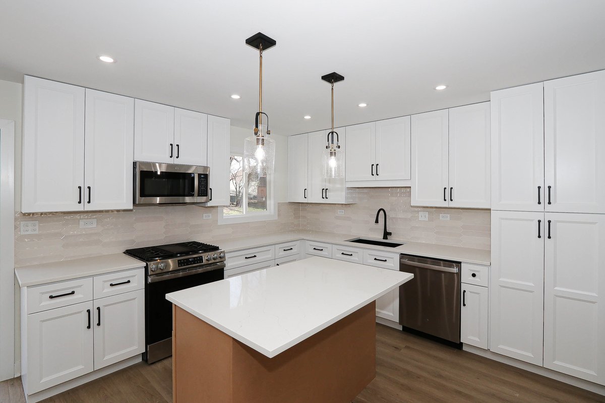 464 Winterwood Drive Roselle, IL 60172 - Photo 8 of 39 a kitchen with stainless steel appliances a white stove top oven a sink dishwasher and a refrigerator with wooden floor