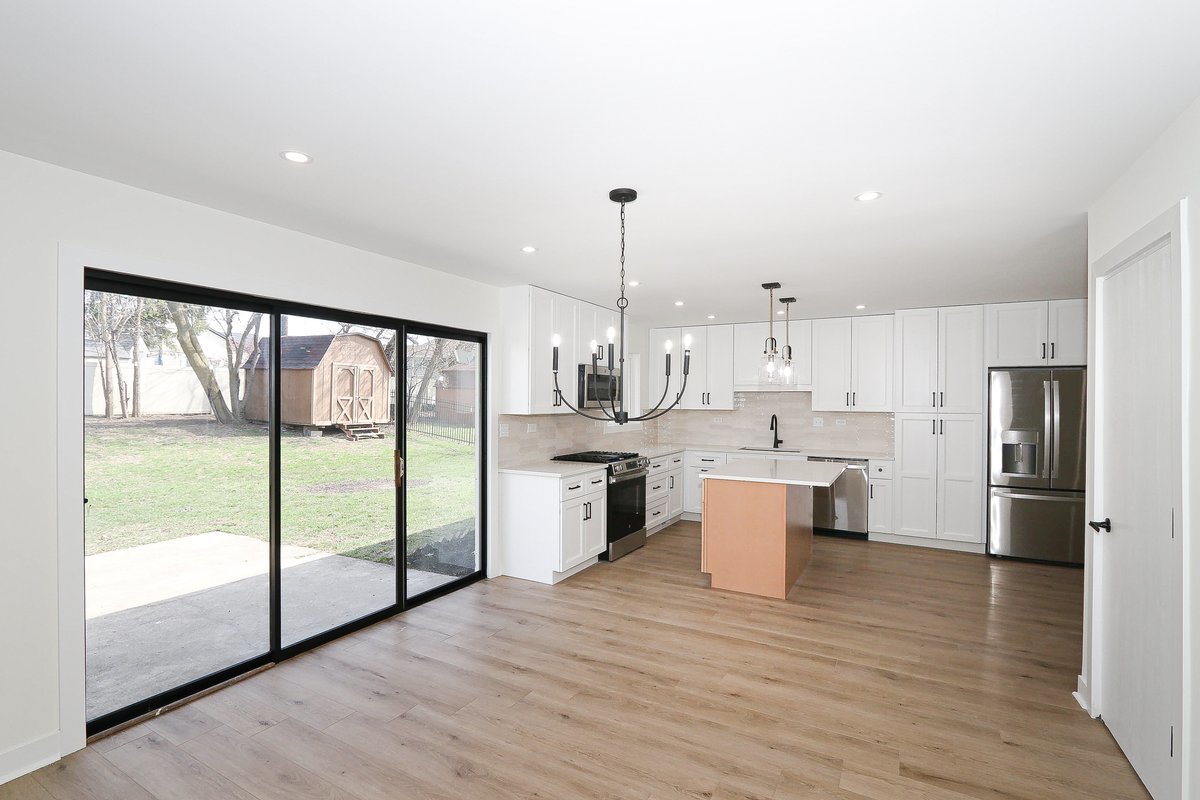 464 Winterwood Drive Roselle, IL 60172 - Photo 9 of 39 a large kitchen with a large counter top appliances and cabinets