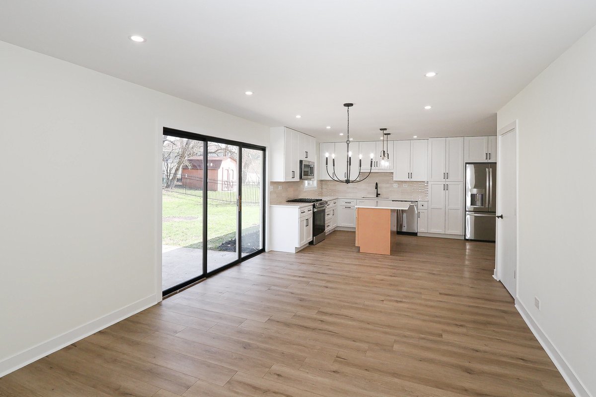464 Winterwood Drive Roselle, IL 60172 - Photo 10 of 39 a large kitchen with stainless steel appliances granite countertop a stove and a refrigerator