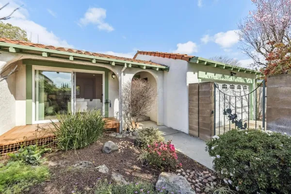 a view of a house with a flower garden