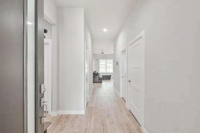 a view of a hallway with wooden floor