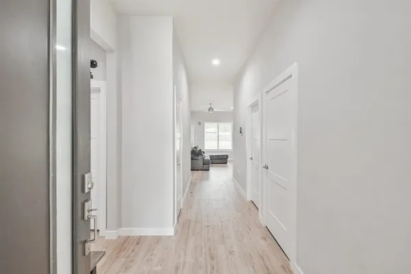 a view of a hallway with wooden floor