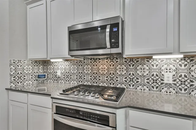 a kitchen with a stove and microwave
