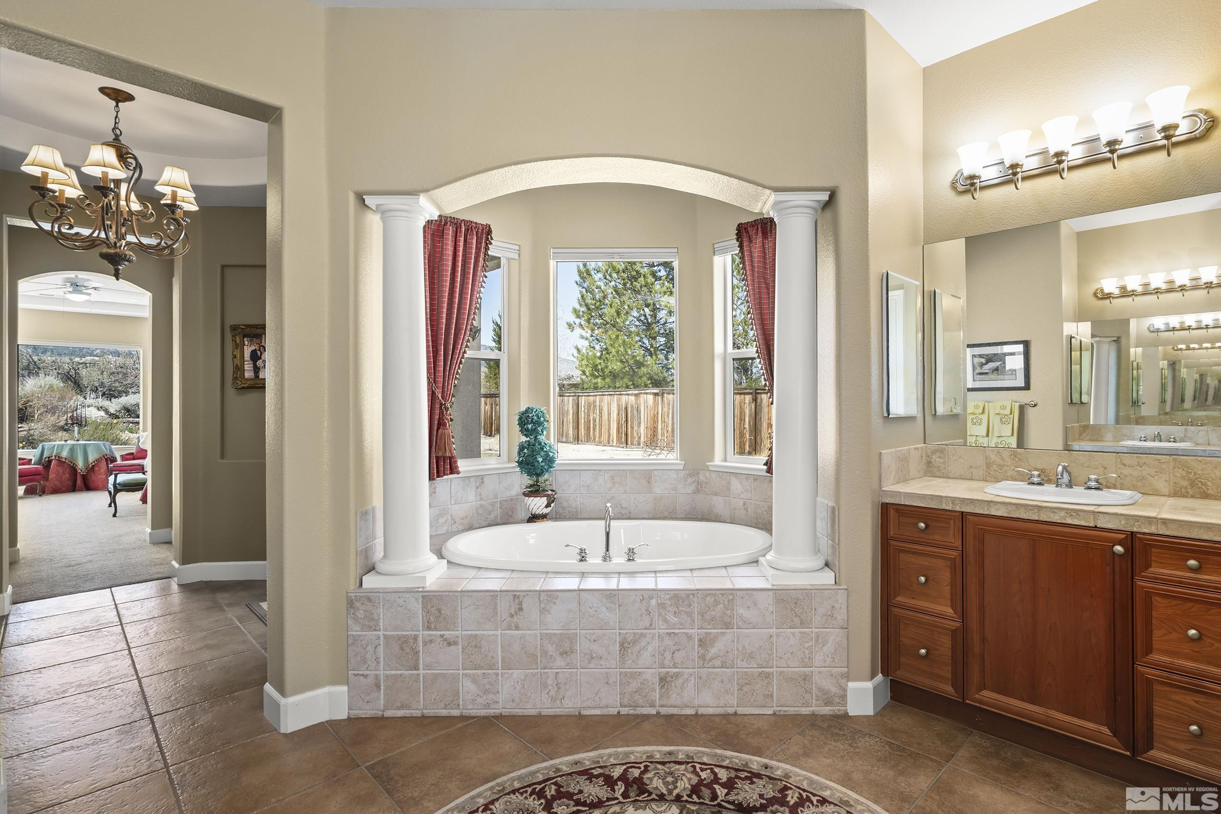 15300 Redmond Loop Reno, NV 89511 - Photo 19 of 35 a spacious bathroom with a tub sink and mirror