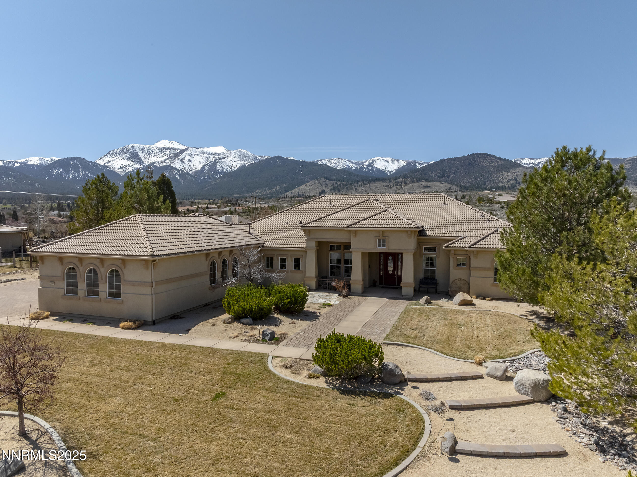 15300 Redmond Loop Reno, NV 89511 - Photo 2 of 35 a front view of a house with a yard and mountain view