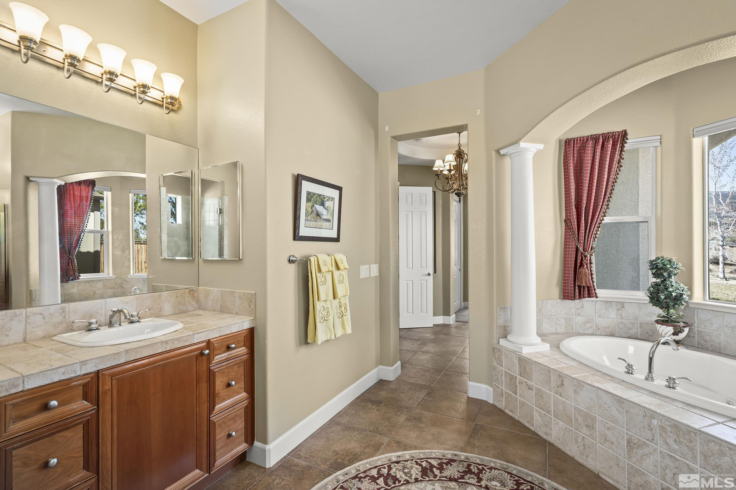 15300 Redmond Loop Reno, NV 89511 - Photo 21 of 35 a spacious bathroom with a tub sink and mirror