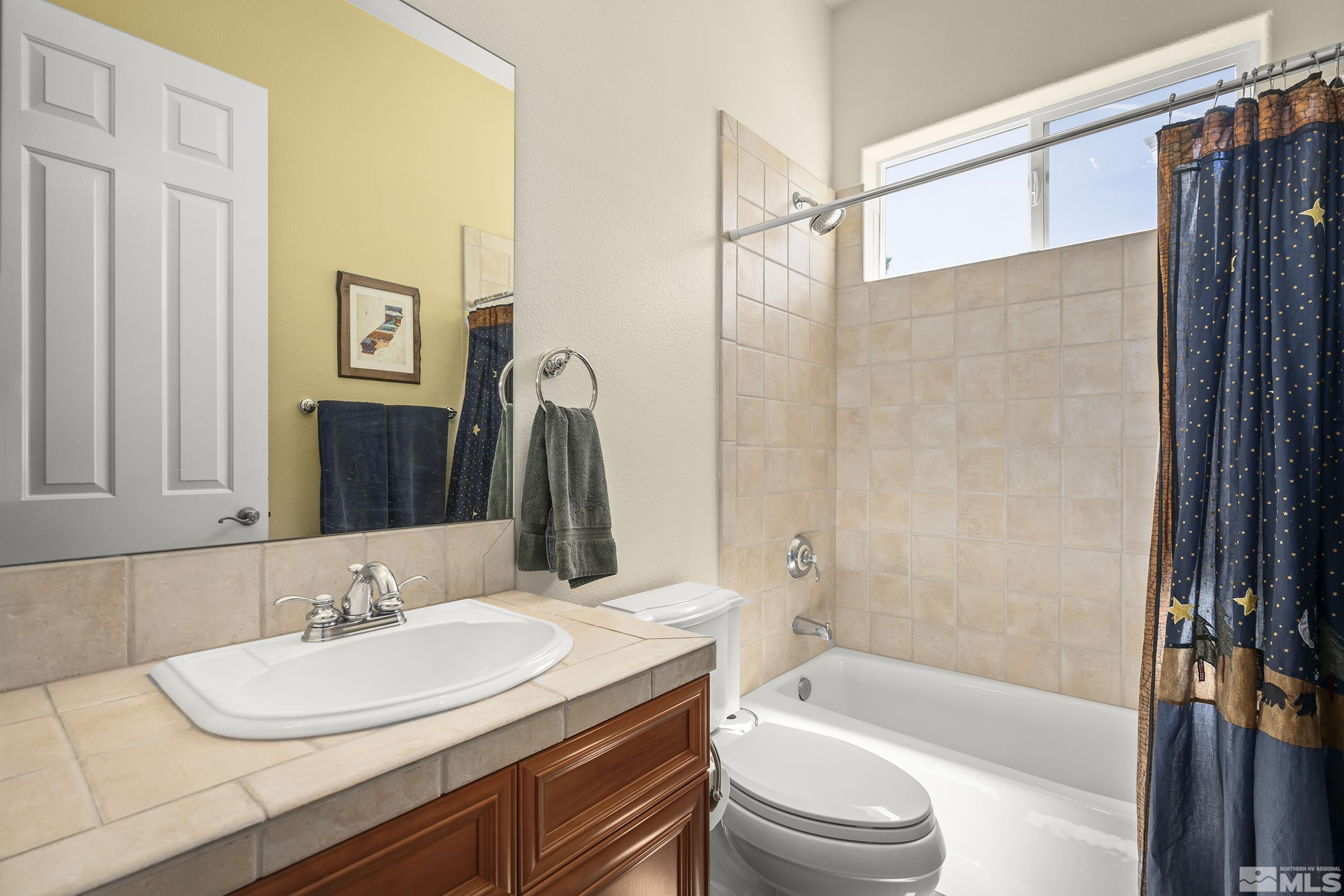 15300 Redmond Loop Reno, NV 89511 - Photo 23 of 35 a bathroom with a sink a toilet and a bathtub