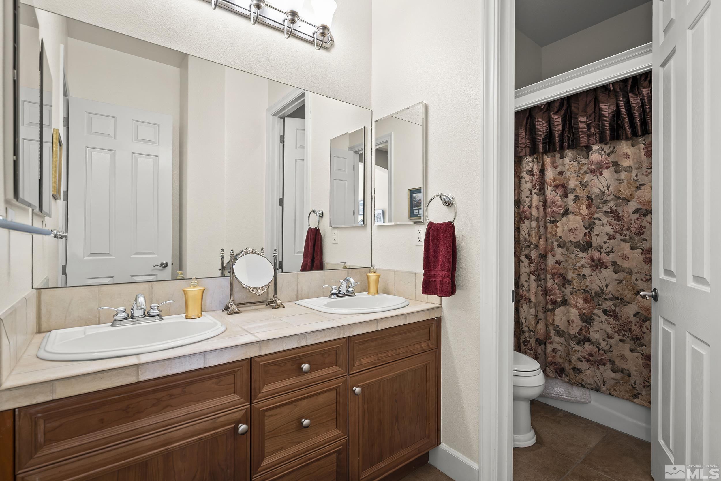 15300 Redmond Loop Reno, NV 89511 - Photo 26 of 35 a bathroom with a double vanity sink and a mirror