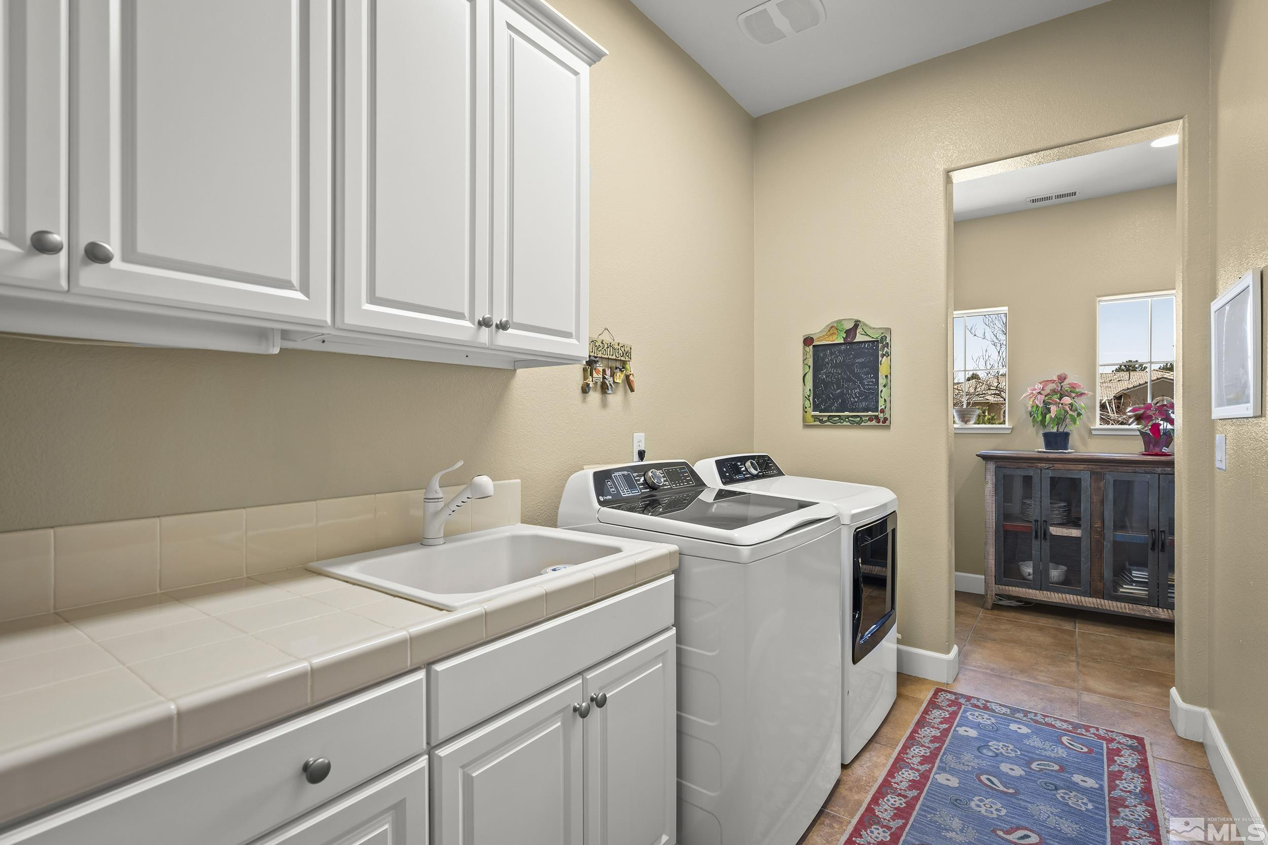 15300 Redmond Loop Reno, NV 89511 - Photo 30 of 35 a view of a storage and utility room with washer and dryer
