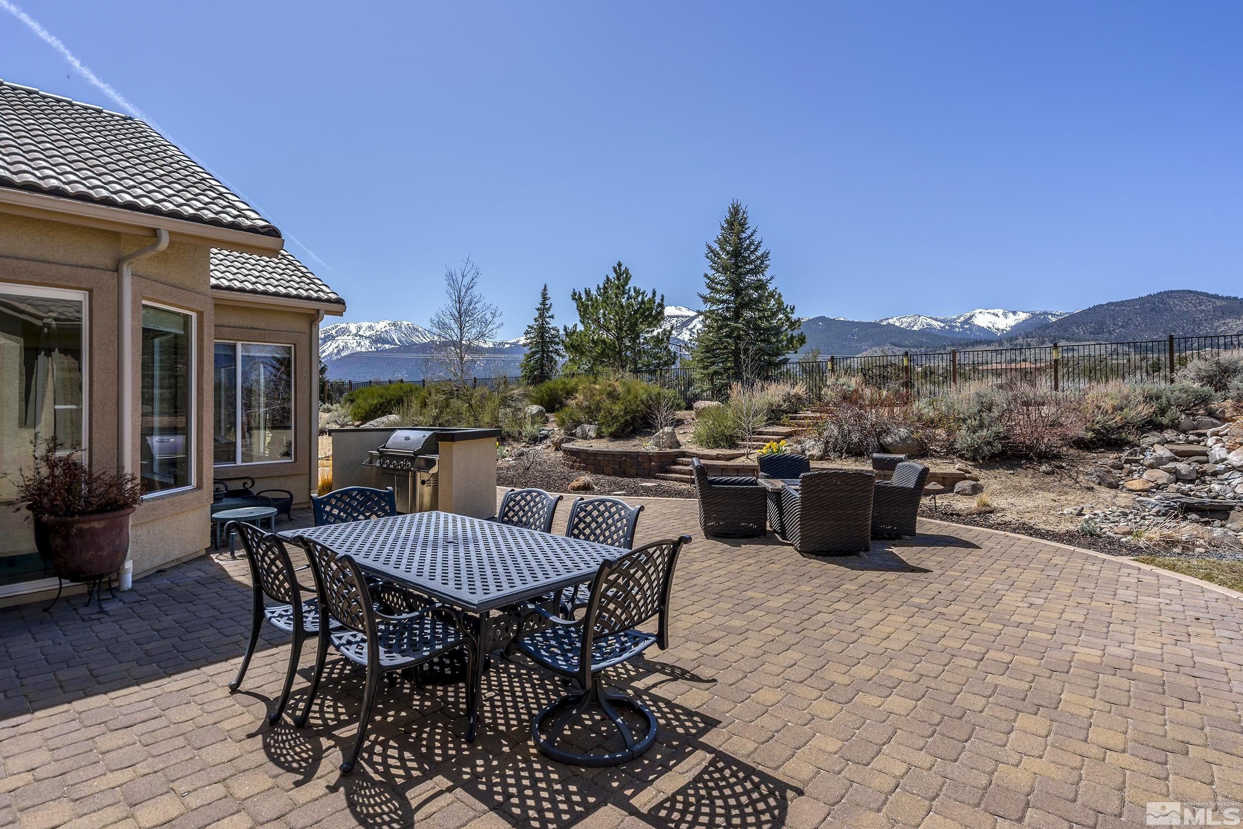 15300 Redmond Loop Reno, NV 89511 - Photo 31 of 35 a view of a patio with a dining table and chairs with wooden floor