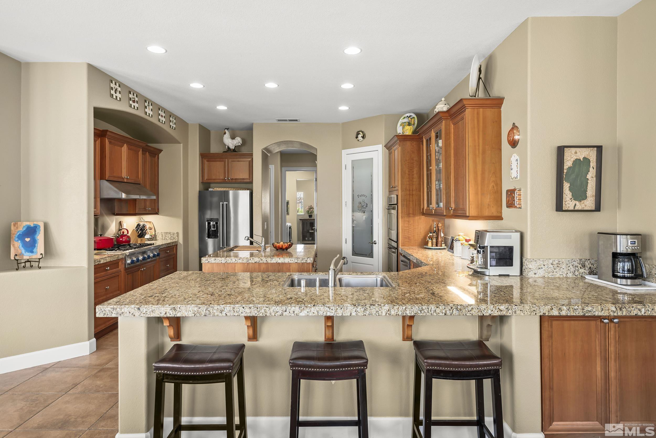 15300 Redmond Loop Reno, NV 89511 - Photo 6 of 35 a kitchen with kitchen island granite countertop a table and chairs in it