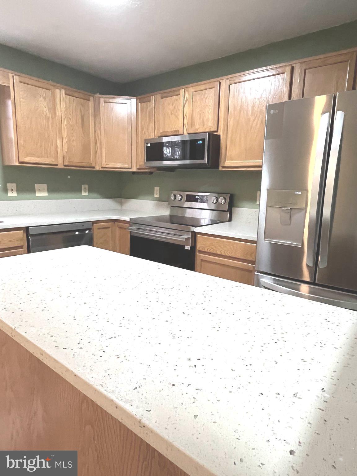 305 Sutton Court Winchester, VA 22601 - Photo 13 of 40 a kitchen with stainless steel appliances granite countertop a refrigerator a sink a stove and microwave