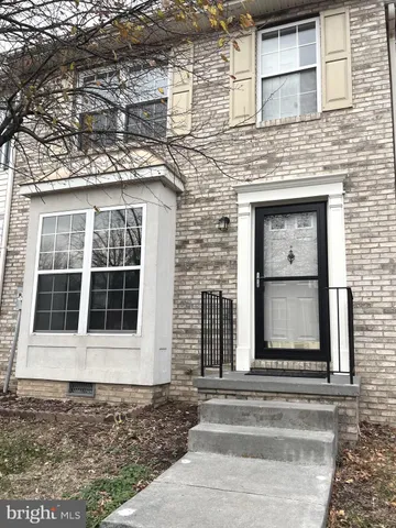 front view of a brick house with a window and door