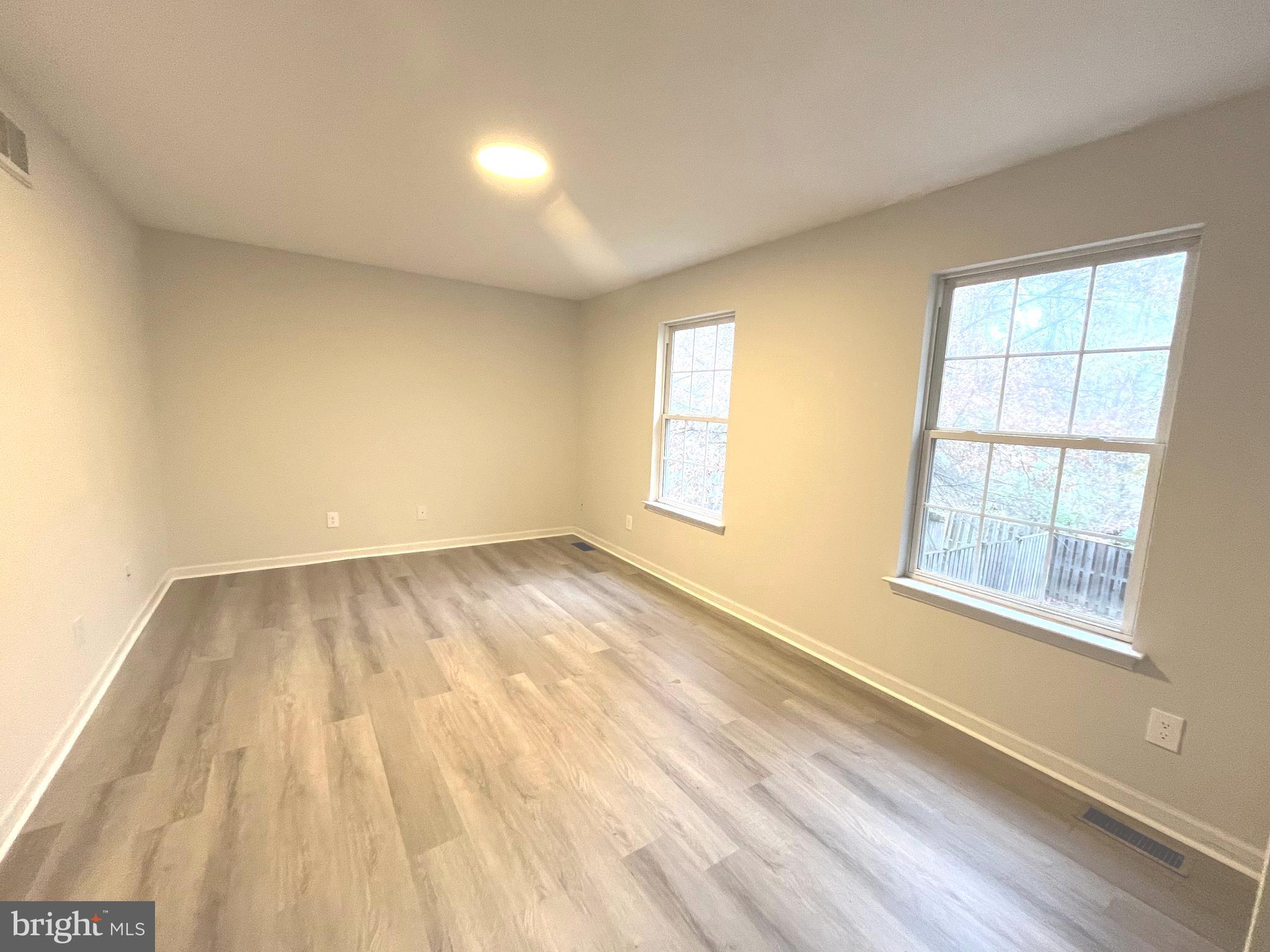 305 Sutton Court Winchester, VA 22601 - Photo 28 of 40 an empty room with wooden floor and windows