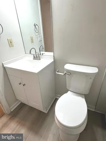 a white toilet sitting next to a bathroom sink