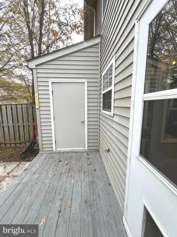 a view of a small space with wooden floor and a window
