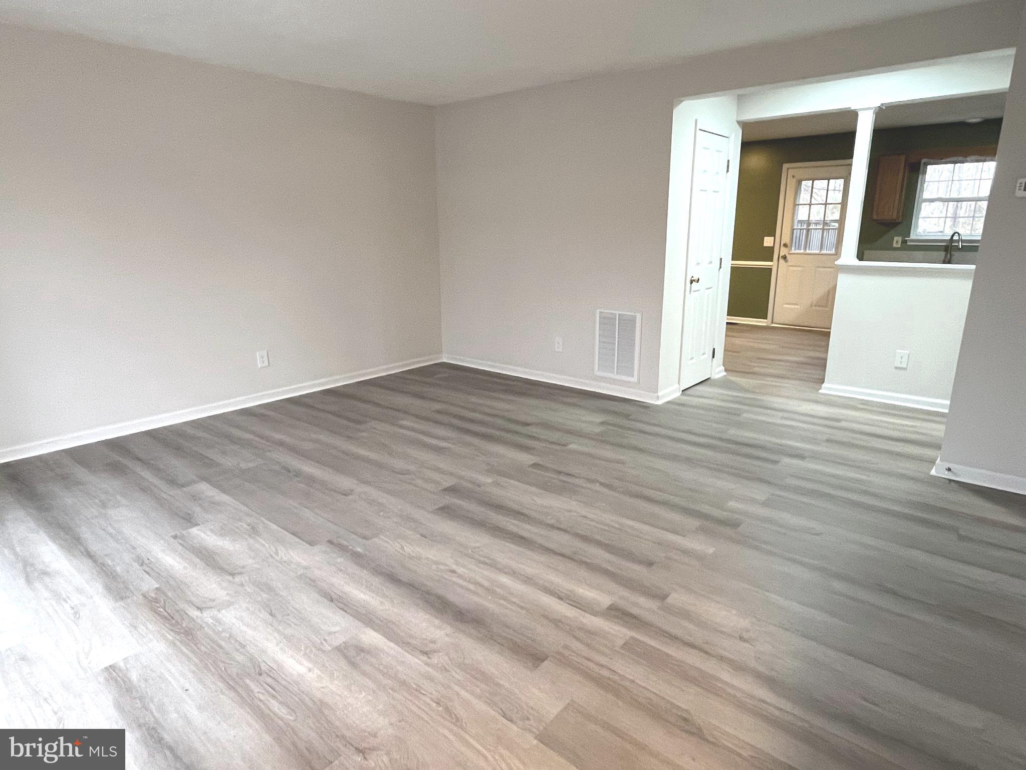 305 Sutton Court Winchester, VA 22601 - Photo 4 of 40 a view of a livingroom with wooden floor and staircase