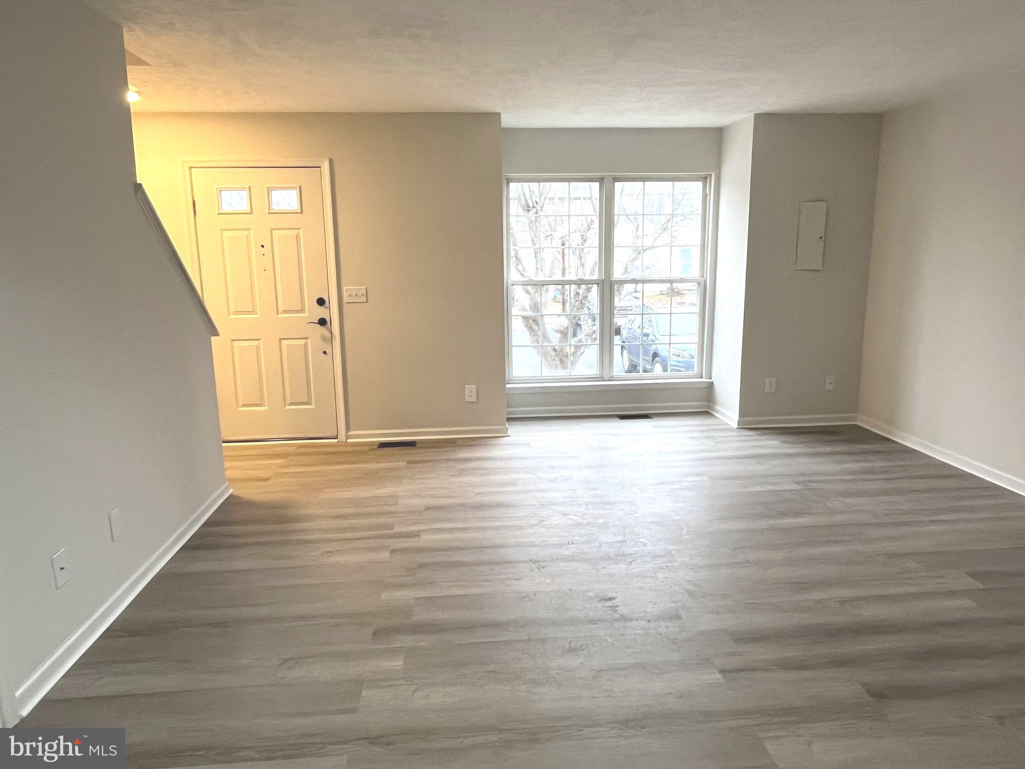 305 Sutton Court Winchester, VA 22601 - Photo 5 of 40 an empty room with wooden floor and windows