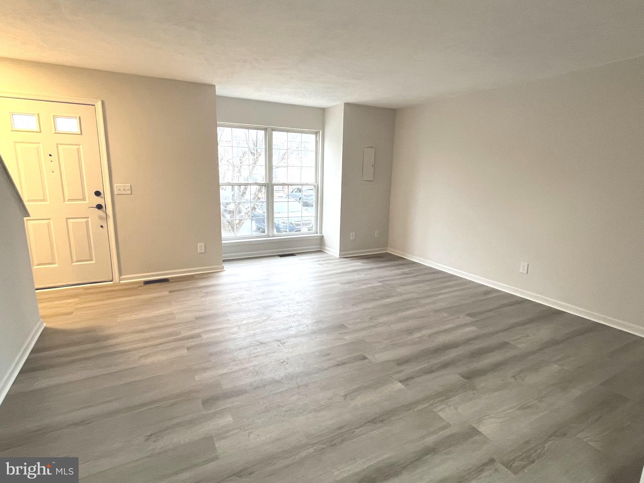 305 Sutton Court Winchester, VA 22601 - Photo 8 of 40 an empty room with wooden floor and windows