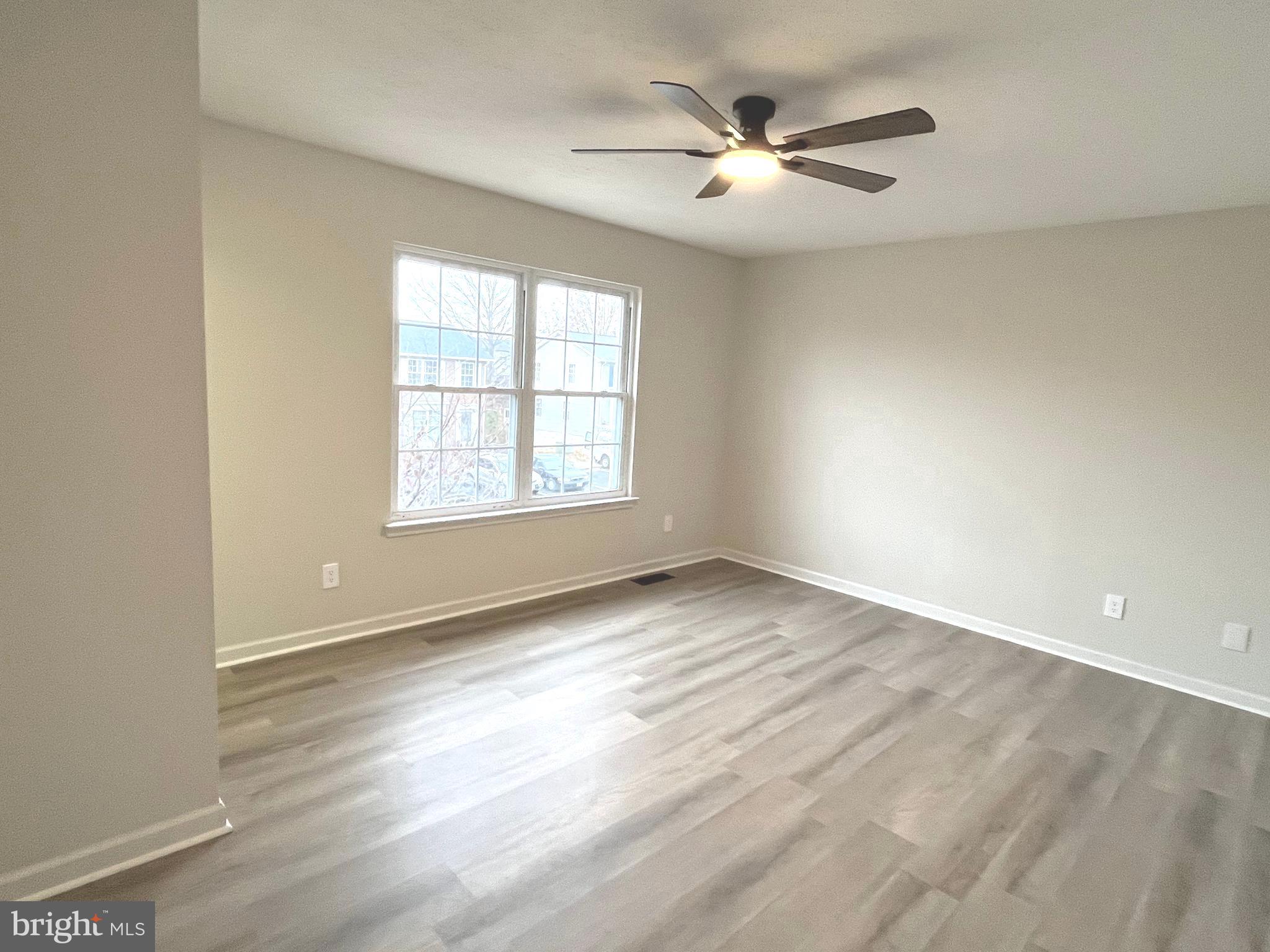 305 Sutton Court Winchester, VA 22601 - Photo 10 of 40 an empty room with wooden floor and windows
