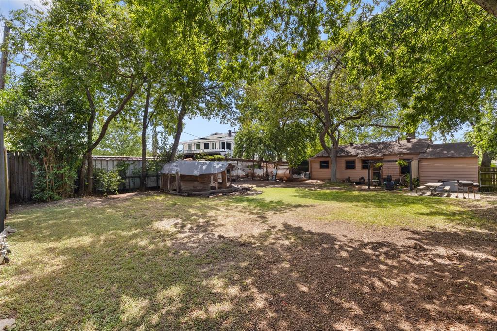 1703 Brandon Street Dallas, TX 75208 - Photo 1 of 16 a view of a yard with a tree