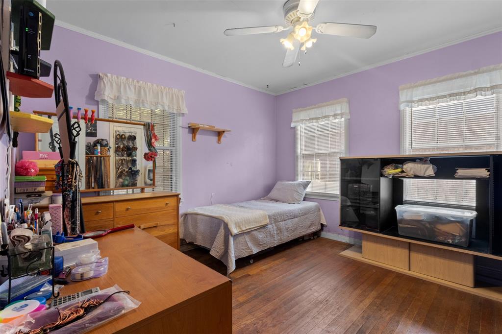 1703 Brandon Street Dallas, TX 75208 - Photo 11 of 16 a bedroom with bed and a large window