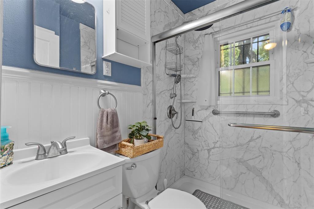 1703 Brandon Street Dallas, TX 75208 - Photo 12 of 16 a bathroom with a sink toilet and shower