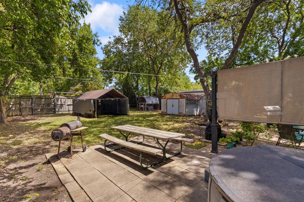 1703 Brandon Street Dallas, TX 75208 - Photo 15 of 16 a backyard of a house with barbeque oven table and chairs