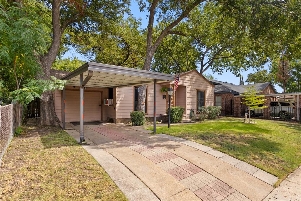 1703 Brandon Street Dallas, TX 75208 - Photo 3 of 16 a front view of a house with a yard