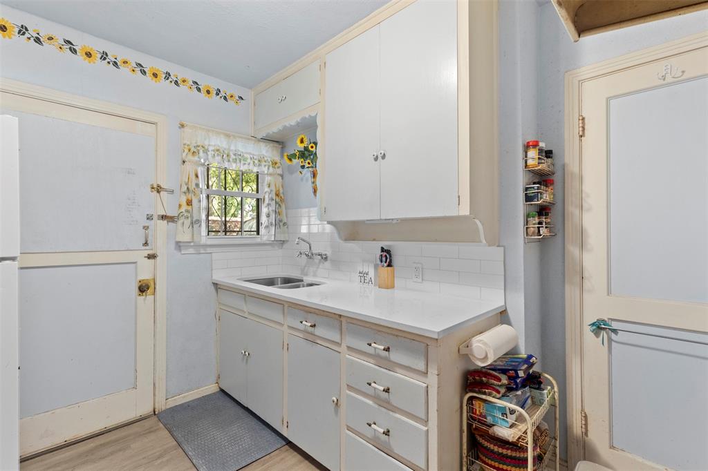 1703 Brandon Street Dallas, TX 75208 - Photo 8 of 16 a utility room with cabinets washer and dryer