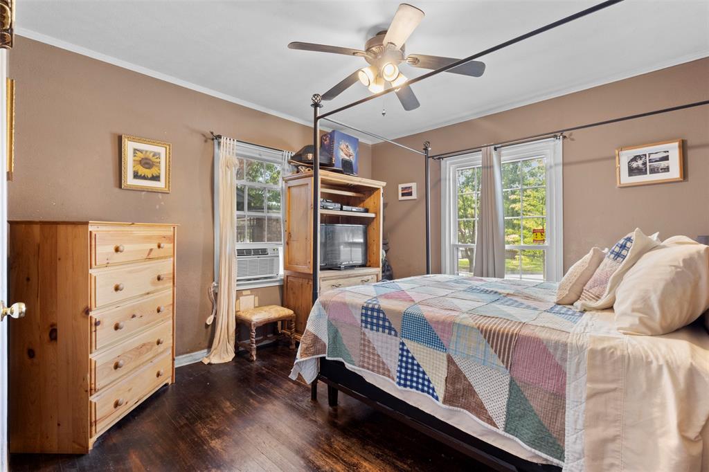1703 Brandon Street Dallas, TX 75208 - Photo 10 of 16 a bedroom with a bed and a chandelier