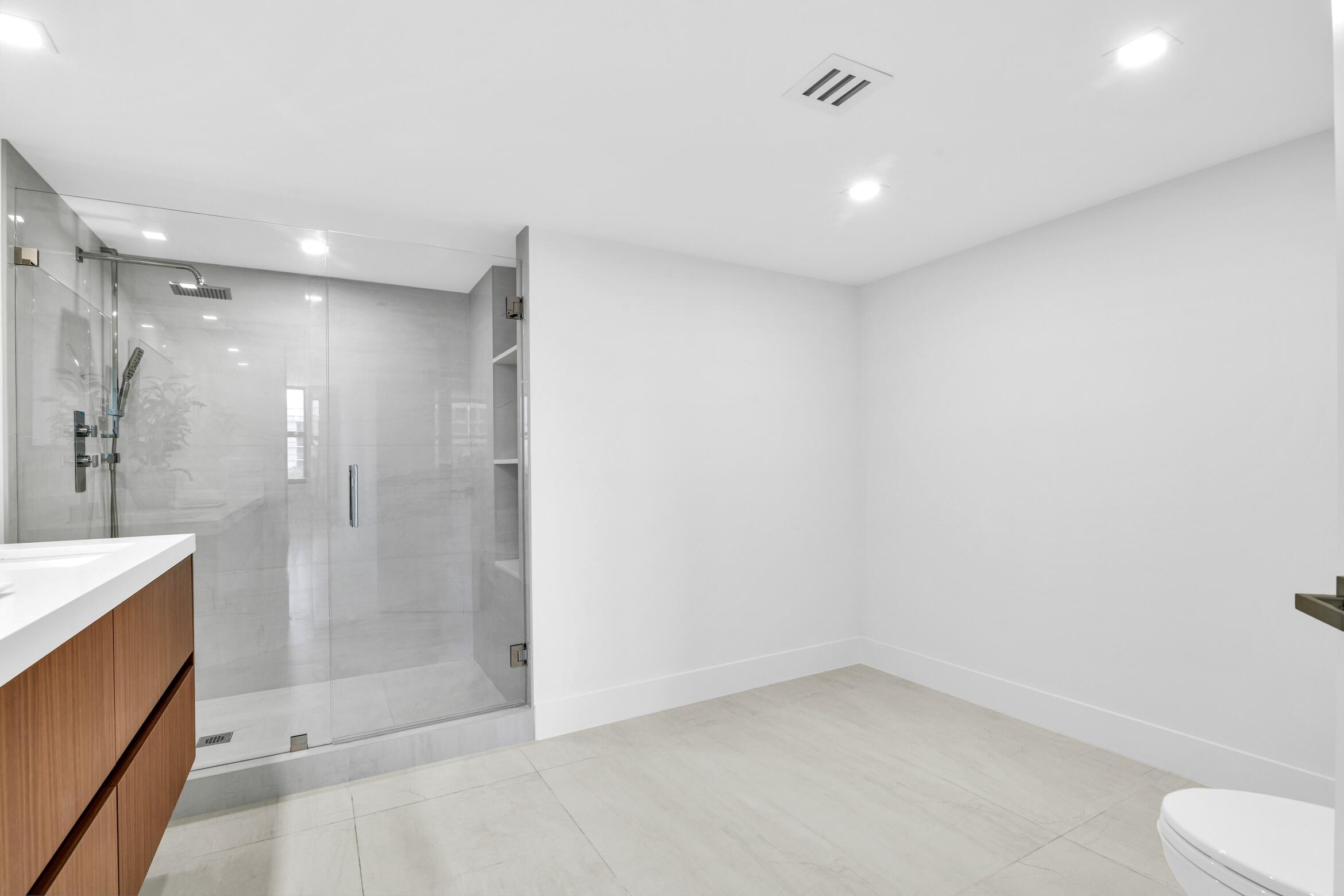2001 North Ocean Boulevard, Unit 502 Boca Raton, FL 33431 - Photo 29 of 67 a bathroom with a shower and toilet