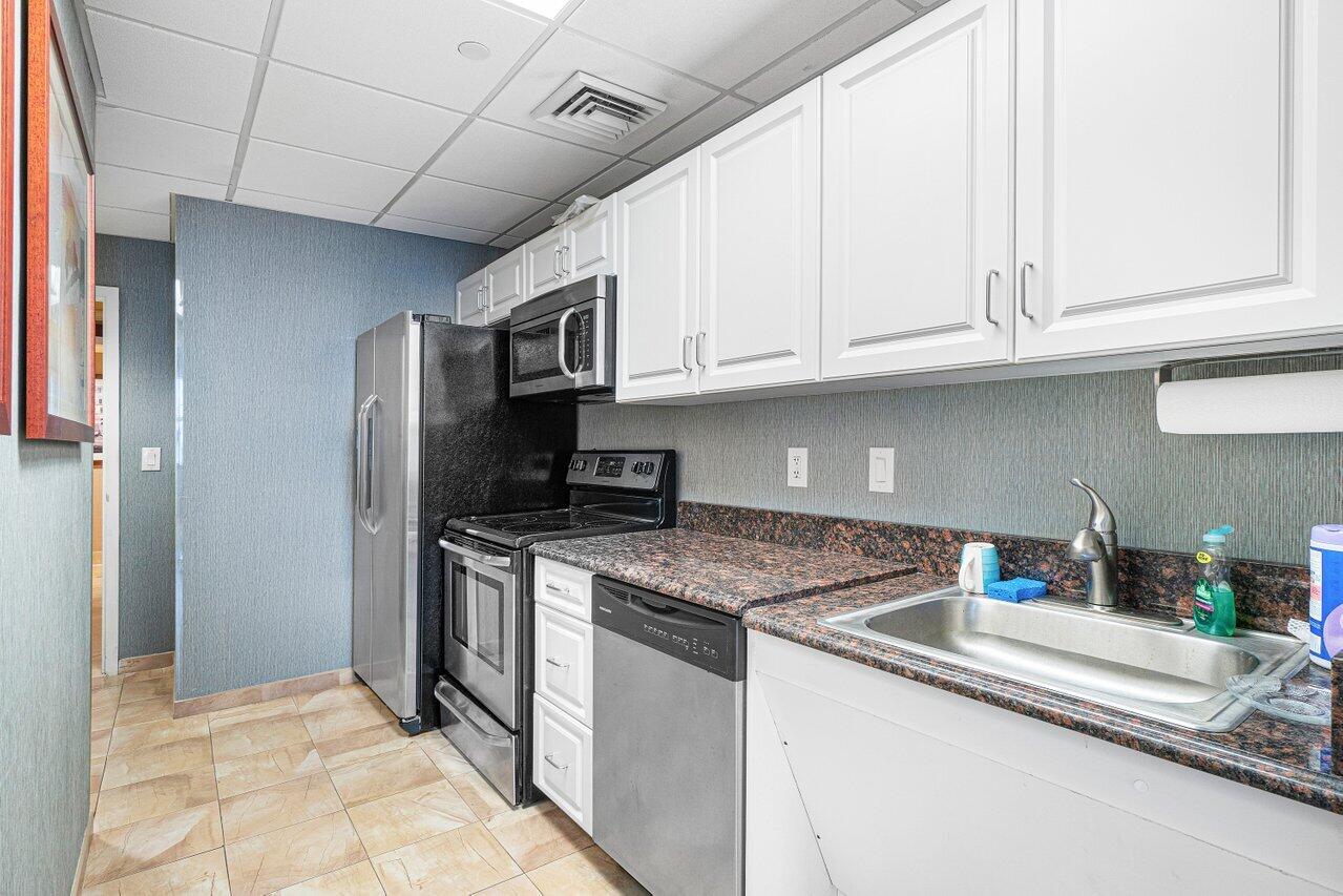 2001 North Ocean Boulevard, Unit 502 Boca Raton, FL 33431 - Photo 54 of 67 a kitchen with stainless steel appliances granite countertop a sink stove and refrigerator