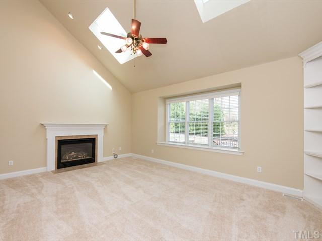 9216 Club Hill Drive Raleigh, NC 27617 - Photo 13 of 25 a view of an empty room with chandelier fan and fire place