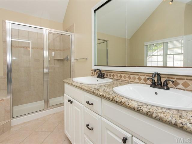 9216 Club Hill Drive Raleigh, NC 27617 - Photo 16 of 25 a bathroom with a granite countertop sink mirror and shower