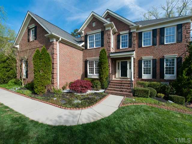 9216 Club Hill Drive Raleigh, NC 27617 - Photo 2 of 25 a front view of a house with a yard and potted plants