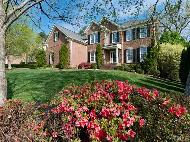 9216 Club Hill Drive Raleigh, NC 27617 - Photo 21 of 25 a front view of a house with a big yard and potted plants