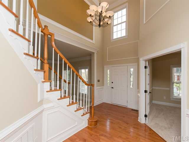 9216 Club Hill Drive Raleigh, NC 27617 - Photo 3 of 25 a view of a hallway with wooden floor and staircase