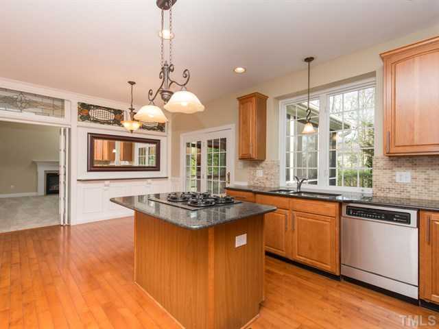 9216 Club Hill Drive Raleigh, NC 27617 - Photo 5 of 25 a kitchen with stainless steel appliances granite countertop stove a sink dishwasher and a refrigerator with wooden floor