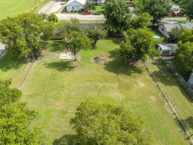 a view of a swimming pool with an outdoor seating and a yard