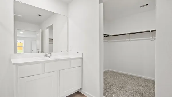 a bathroom with a double vanity sink and mirror