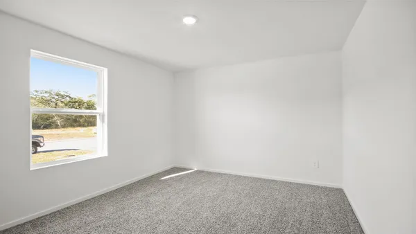 a view of an empty room with a painting on the wall