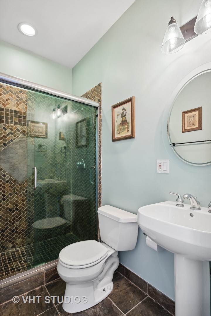 523 North Racine Avenue, Unit 4 Chicago, IL 60642 - Photo 16 of 17 a bathroom with a toilet sink and shower