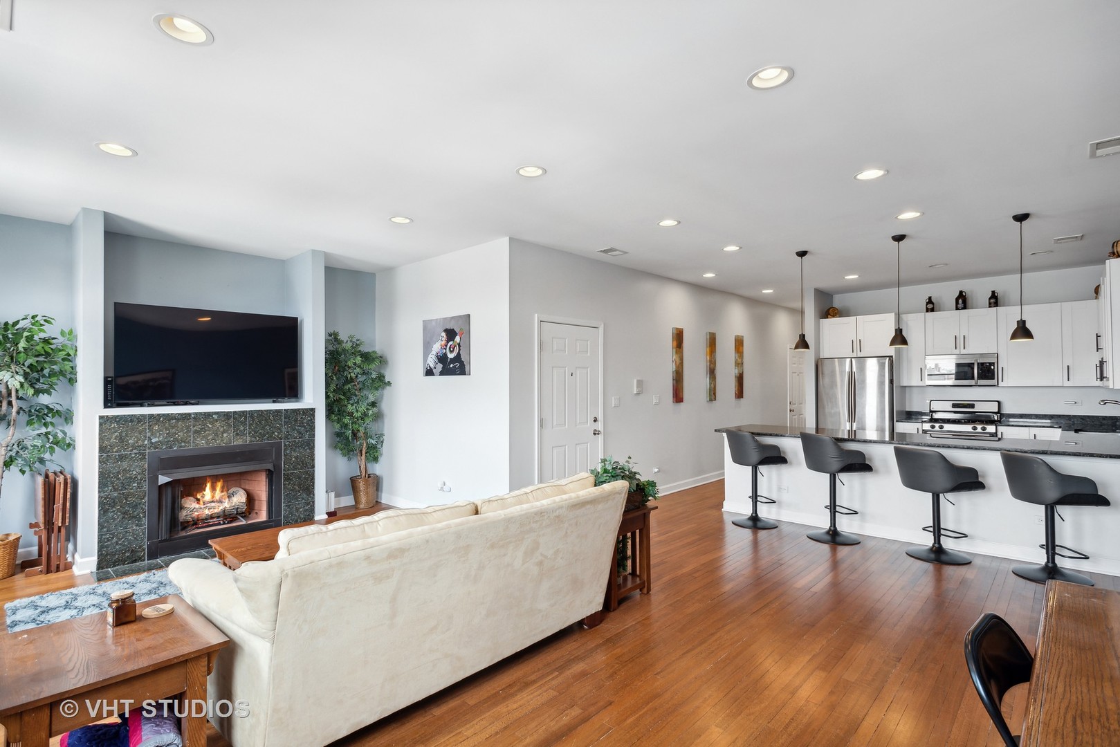 523 North Racine Avenue, Unit 4 Chicago, IL 60642 - Photo 3 of 17 a living room with furniture and a fireplace